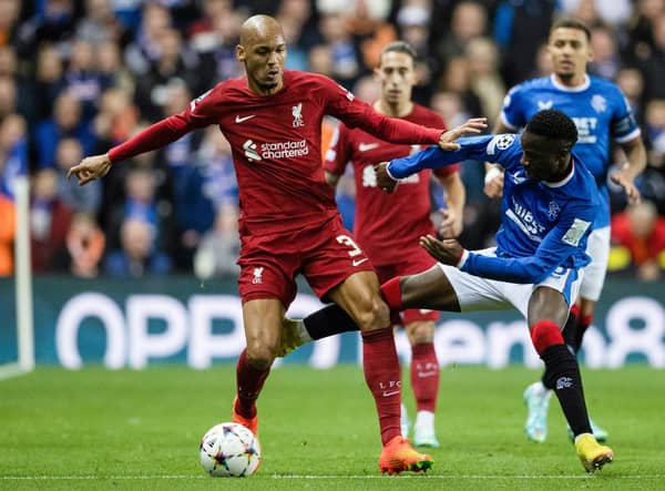 Rangers' Fashion Sakala competes with Liverpool's Fabinho during their match at Ibrox.