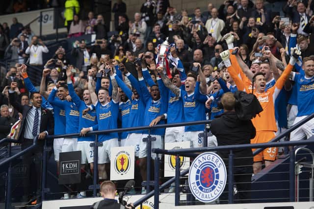 The triumphant Rangers team celebrate winning the Scottish Cup back in May.