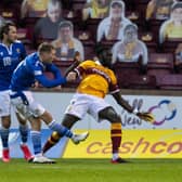 A crowd of cardboard cut-outs watches St Johnstone's David Wotherspoon take a shot during a Betfred Cup match against Motherwell (Picture: Ross MacDonald/SNS Group)
