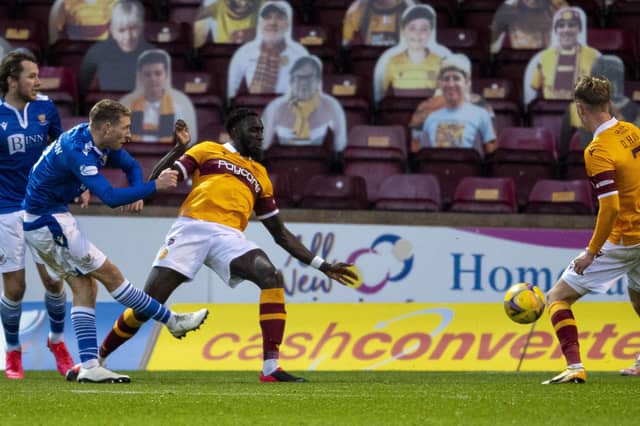 A crowd of cardboard cut-outs watches St Johnstone's David Wotherspoon take a shot during a Betfred Cup match against Motherwell (Picture: Ross MacDonald/SNS Group)