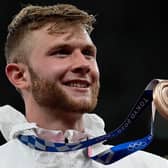 Britain's Josh Kerr with his bronze medal on the podium after the men's 1500m event during the Tokyo 2020 Olympic. Picture: AFP via Getty Images