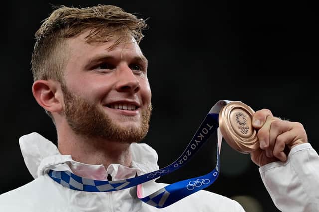 Britain's Josh Kerr with his bronze medal on the podium after the men's 1500m event during the Tokyo 2020 Olympic. Picture: AFP via Getty Images