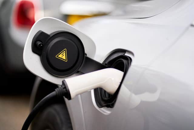 An electric car plugged into an EV charging point. PIC: John Walton/PA Wire