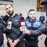 Influencer Andrew Tate leaves Romania's anti-organised crime and terrorism directorate after questioning (Picture: Mihai Barbu/AFP via Getty Images)