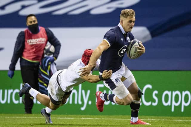 Duhan van der Merwe breaks past Akaki Tabutsadze. The winger marked his Scotland debut with a try.