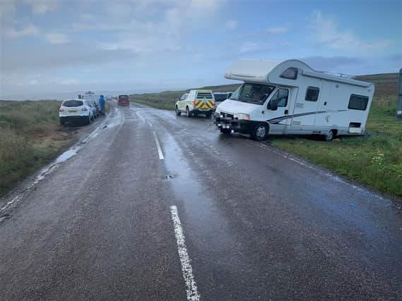 The camper van was stranded by the road but presented a potential danger to traffic.