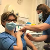 Lynsey Mackenzie receiving the vaccine from occupational health nurse Marion Campbell.