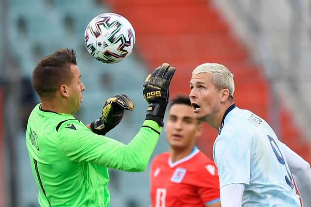 Scotland's forward Lyndon Dykes (R) challenges Luxembourg's goalkeeper Anthony Moris during the friendly football match between Luxembourg and Scotland at the Josy Barthel Stadium in Luxembourg on June 6, 2021. (Photo by JOHN THYS/AFP via Getty Images)