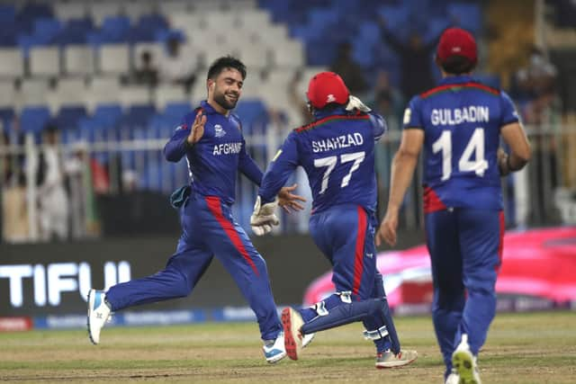 Afghanistan's Rashid Khan celebrates the wicket of Scotland's Brad Wheal during the Cricket Twenty20 World Cup match between Afghanistan and Scotland in Sharjah, UAE, Monday, Oct. 25, 2021. (AP Photo/Aijaz Rahi)