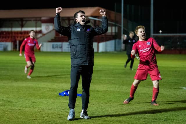 BRORA, SCOTLAND - MARCH 23: Brora manager Steven MacKay and his players celebrate.