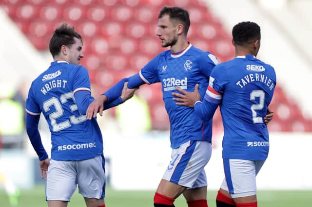 Rangers' Borna Barisic is held back after reacting to Motherwell fans.