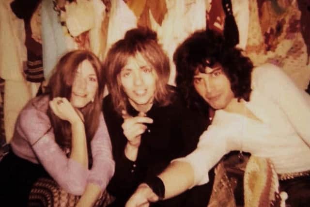 Freddie Mercury (right), Roger Taylor (centre), and Mary Austin in Alan Mair's stall at Kensington Market in 1970.