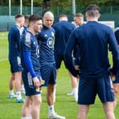 Scotland captain Andy Robertson (left) in conversation with team-mates and manager Steve Clarke (right) during training at the Oriam in Edinburgh on Tuesday. (Photo by Mark Scates / SNS Group)