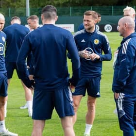 Scotland captain Andy Robertson (left) in conversation with team-mates and manager Steve Clarke (right) during training at the Oriam in Edinburgh on Tuesday. (Photo by Mark Scates / SNS Group)