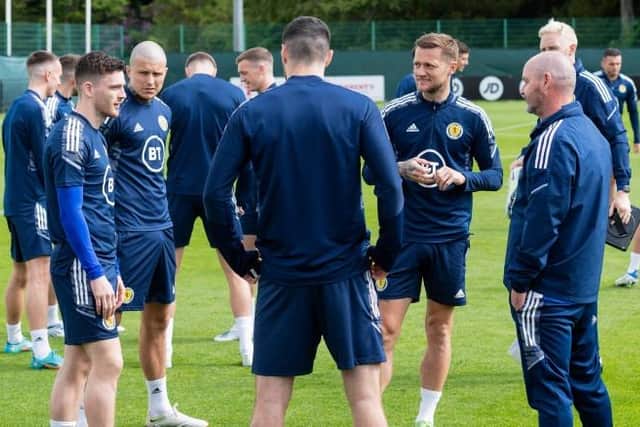 Scotland captain Andy Robertson (left) in conversation with team-mates and manager Steve Clarke (right) during training at the Oriam in Edinburgh on Tuesday. (Photo by Mark Scates / SNS Group)
