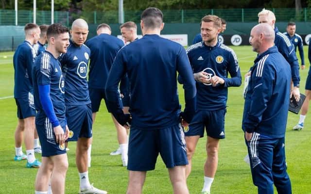 Scotland captain Andy Robertson (left) in conversation with team-mates and manager Steve Clarke (right) during training at the Oriam in Edinburgh on Tuesday. (Photo by Mark Scates / SNS Group)