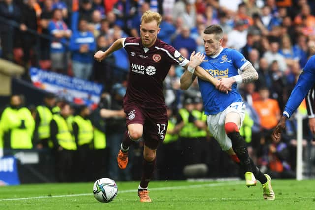 Hearts' wing-back Nathaniel Atkinson is held back by Rangers winger Ryan Kent during the Scottish Cup final at Hampden Park.  (Photo by Craig Foy / SNS Group)