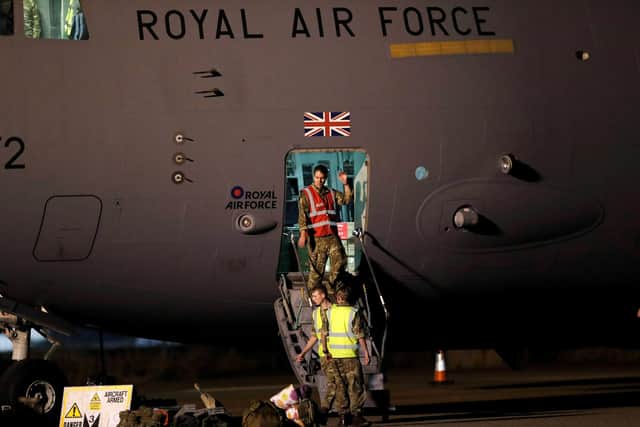 British military personnel depart a C-17 aircraft at RAF Brize Norton, Oxfordshire. The final UK troops and diplomatic staff were airlifted from Kabul on Saturday, drawing to a close Britain's 20-year engagement in Afghanistan and a two-week operation to rescue UK nationals and Afghan allies.