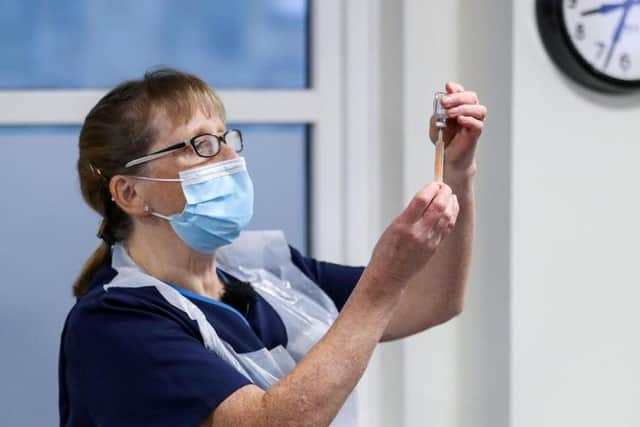 Practice Nurse Ruth Davies holds a vial of the Oxford/AstraZeneca coronavirus vaccine at Pentlands Medical Centre in Edinburgh.