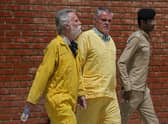 Jim Fitton of Britain, left, and Volker Waldman  escorted by Iraqi security forces, outside a courtroom, in Baghdad