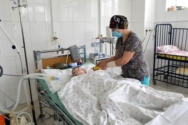 A doctor takes care of a boy injured by the shelling in Ukraine's second-biggest city, Kharkiv, last week (Picture: Sergey Bobok/AFP via Getty Images)