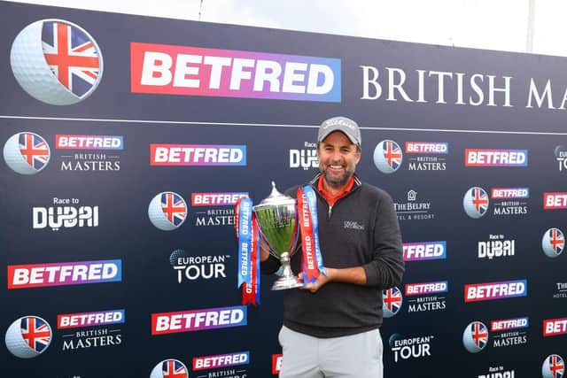 Richard Bland poses with the Betfred British Masters trophy after winning a play-off at The Belfry in Sutton Coldfield. Picture: Andrew Redington/Getty Images.