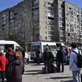 People wait to board buses during their evacuation in Kramatorsk, Ukraine, Saturday, April 9, 2022. After the bombing of the train station Friday, resident are continuing their attempts to leave the city on buses and other transports. (AP Photo/Andriy Andriyenko)