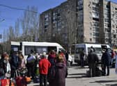 People wait to board buses during their evacuation in Kramatorsk, Ukraine, Saturday, April 9, 2022. After the bombing of the train station Friday, resident are continuing their attempts to leave the city on buses and other transports. (AP Photo/Andriy Andriyenko)
