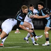Glasgow's Kyle Steyn (centre) is tackled by Ospreys Owen Watkin.