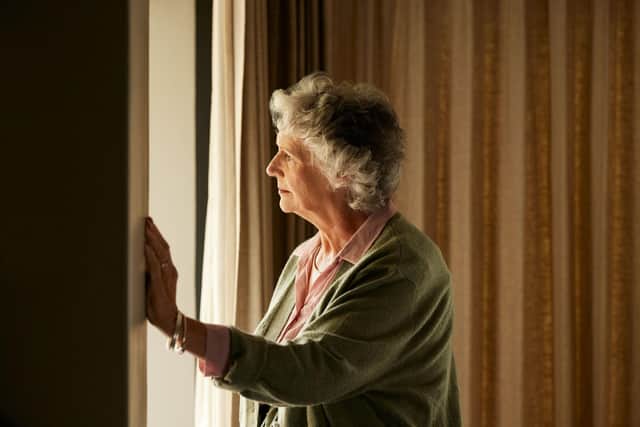 Older lady looking out the window