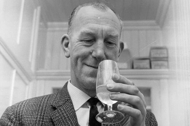 Glenlivet Distillery manager Robert Arthur enjoys a little quality control - by tasting a dram of whisky in March 1967.