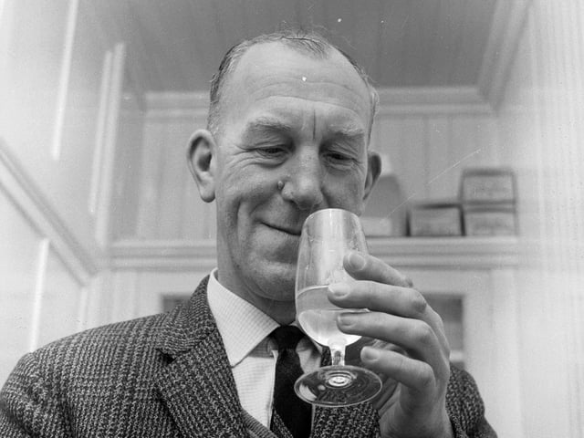Glenlivet Distillery manager Robert Arthur enjoys a little quality control - by tasting a dram of whisky in March 1967.