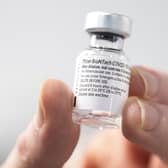 A nurse holds a bottle of Pfizer coronavirus vaccine at the NHS Louisa Jordan Hospital in Glasgow, as part of a mass vaccination drive by NHS Greater Glasgow and Clyde. Photo credit should read: Jane Barlow/PA Wire