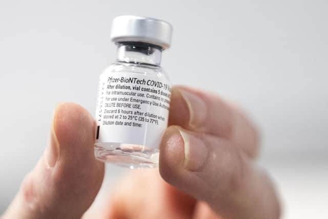 A nurse holds a bottle of Pfizer coronavirus vaccine at the NHS Louisa Jordan Hospital in Glasgow, as part of a mass vaccination drive by NHS Greater Glasgow and Clyde. Photo credit should read: Jane Barlow/PA Wire