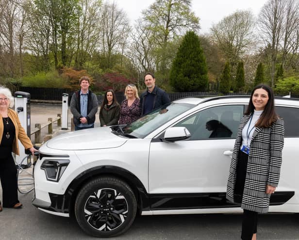 Cllr Anne Simpson (left) tries out the EV charging points at Aden.