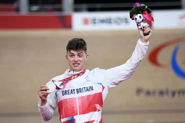 Silver medalist Finlay Graham celebrates on the podium during the medal ceremony for the Track Cycling Men's C3 3000m Individual Pursuit final on day 2 of the Tokyo 2020 Paralympic Games (Photo by Kiyoshi Ota/Getty Images)