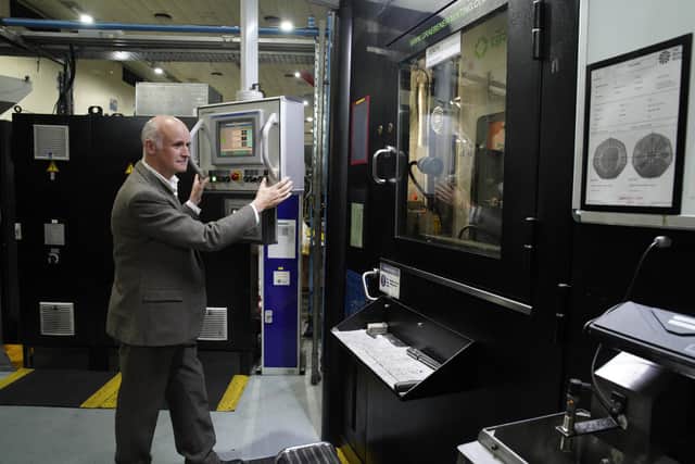 Artist Martin Jennings prepares the first coins featuring the portrait of King Charles III to be struck at The royal Mint in Pontyclun, ahead of them entering circulation from December 28, 2022.