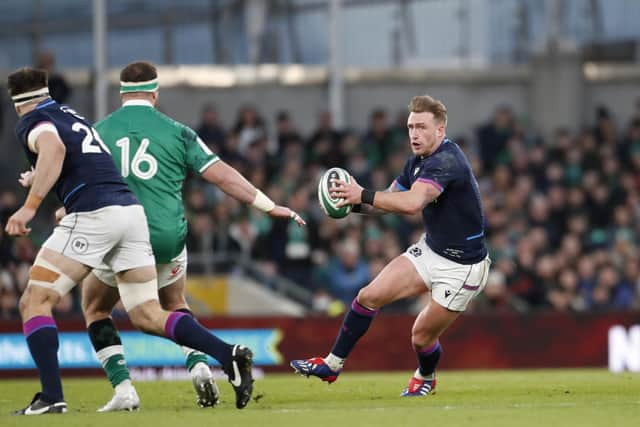 Scotland's Stuart Hogg, right, tries to break through the Irish defence.