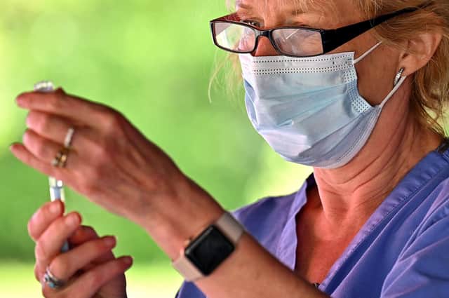 A health worker prepares to vaccinate members of the public on the South Side of Glasgow. Picture: Jeff J Mitchell/Getty Images