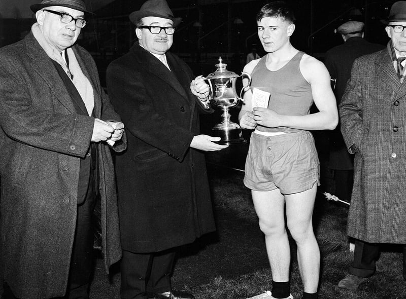 Mr J Harris presents the cup to D Hendrie, the winner of the youth 100 yards handicap at the Powderhall New Year Sprint in 1965.