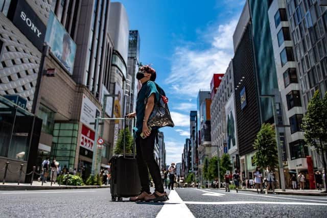 Pedestrians walk on a street in Tokyo's Ginza district. Picture: AFP via Getty Images