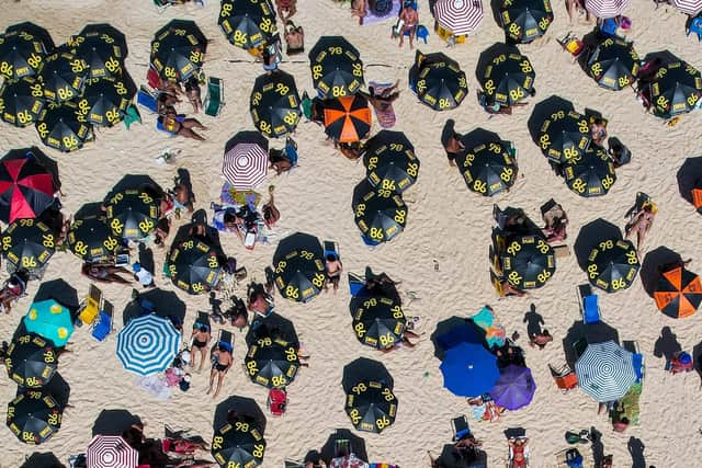 Sun worshippers are seen  at Ipanema Beach in Rio de Janeiro, Brazil.  Photo by Buda Mendes/Getty