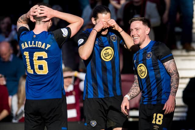 McKay celebrates with Andy Halliday and Peter Haring after his Hearts goal.