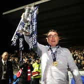 Gary Bowyer lifts the Championship trophy after an astonishing night at Ochilview.
