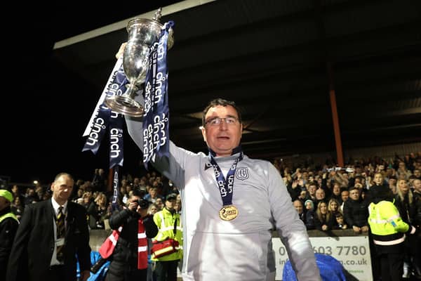 Gary Bowyer lifts the Championship trophy after an astonishing night at Ochilview.