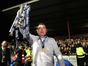 Gary Bowyer lifts the Championship trophy after an astonishing night at Ochilview.