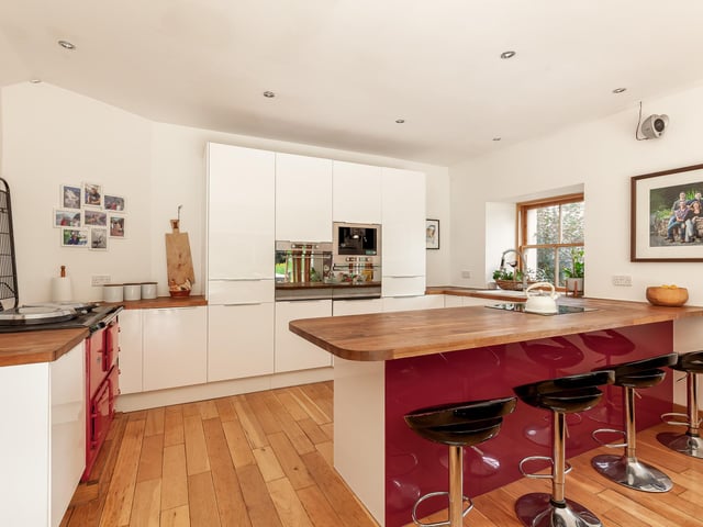 Interior: The cottage is entered via a 200-year-old door and the lounge is kept cosy by a log-burner. Its kitchen and family room has bi-folding doors opening to the garden and there are three bedrooms. Contact Savills