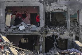 Palestinians inspect the damage in the rubble of a building where two hostages were reportedly held before being rescued during an operation by Israeli security forces in Rafah, on the southern Gaza Strip. Picture: Said Khatib/AFP via Getty Images