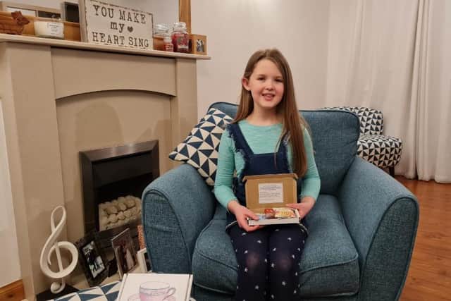 Lily White, nine, has created  100 “Cup of Friendship” boxes containing teabags, coffee sachets, milk, packets of biscuits and cakes for those who lives alone picture: supplied