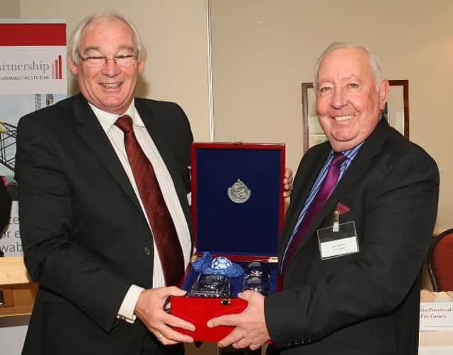 Bill Taylor (right) with his presentation from Provost Jim Leishman